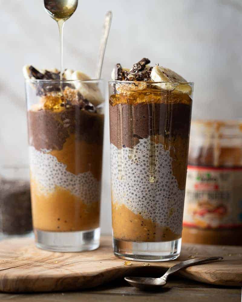 straight shot of 2 glasses full of chocolate peanut butter chia pudding