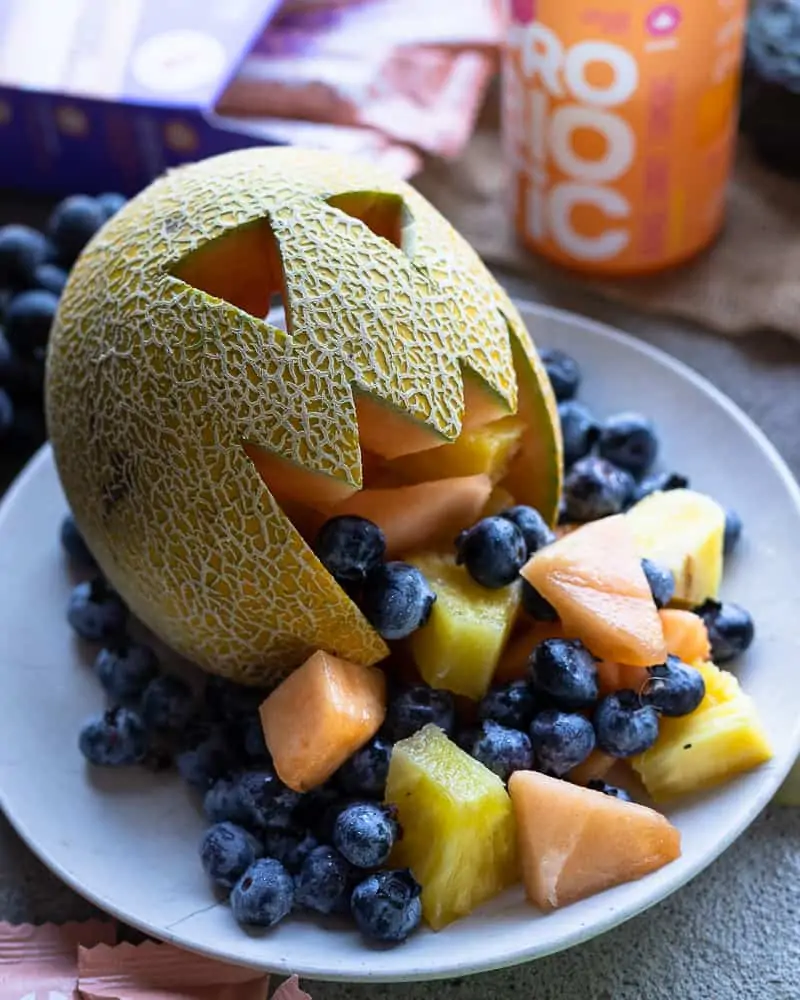 Cantaloupe cut into a face with fruit inside