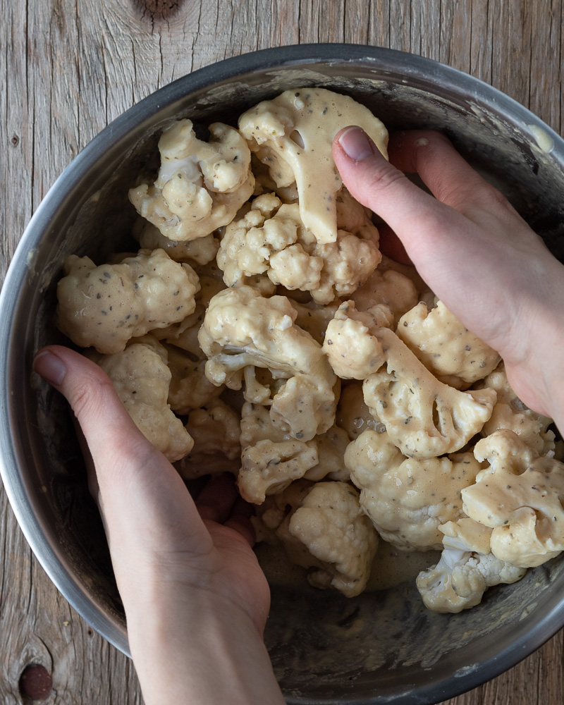 Bowl of cauliflower wings being prepared for a recipe for salt and vinegar wings