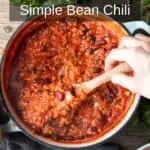 Get dinner on the table in a flash with this easy weeknight bean chili recipe! Made with simple ingredients and packed with flavor, this hearty chili is perfect for busy moms on the go. This image shows a pot of delicious bean chili being stirred with a hand, ready to be enjoyed by the whole family