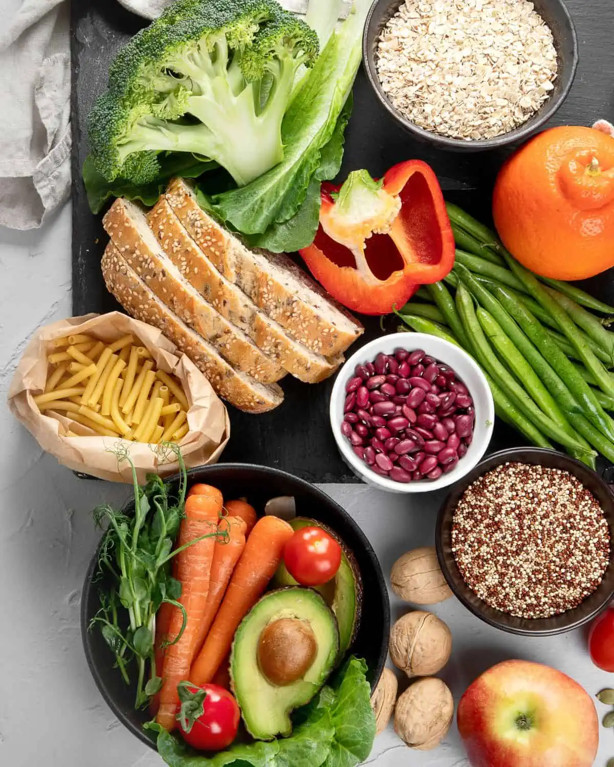 Image of fresh whole foods ona table. the image is to shouw the diversity of whole foods for a post on how to create balanced vegan meals.