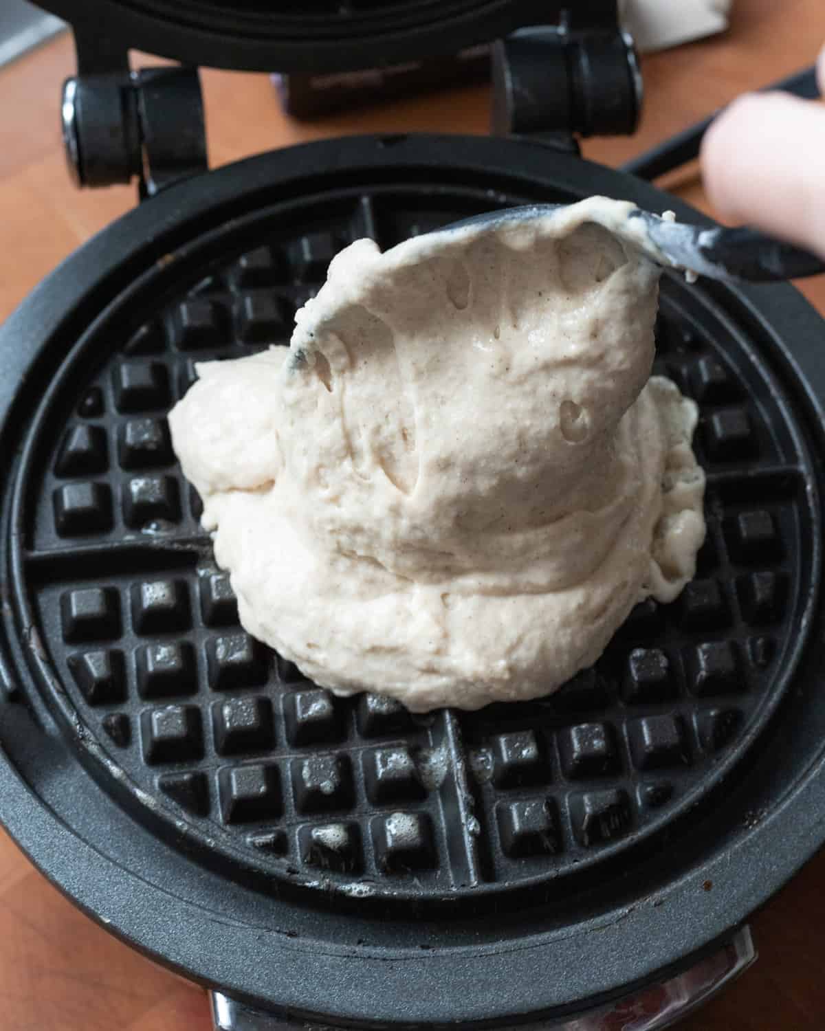Dairy free waffle batter being poured into a waffle maker