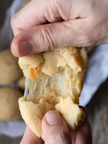 Cover image of a close up of vegan pao de queijo for a recipe post on how make this classic Brazilian snack dairy free.