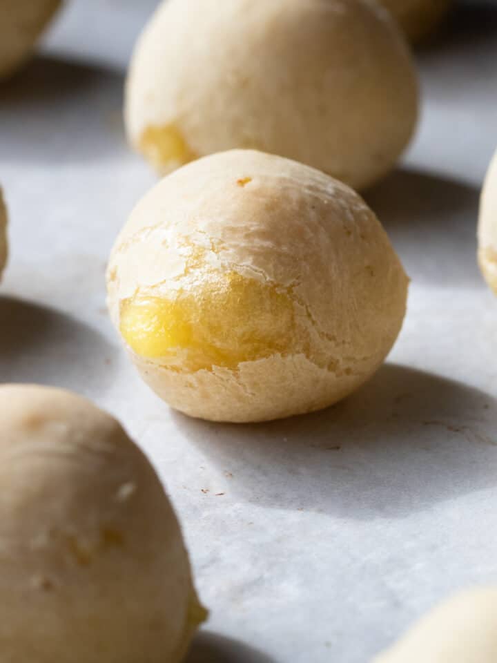 Cover image of a close up of vegan pao de queijo for a recipe post on how make this classic Brazilian snack dairy free.