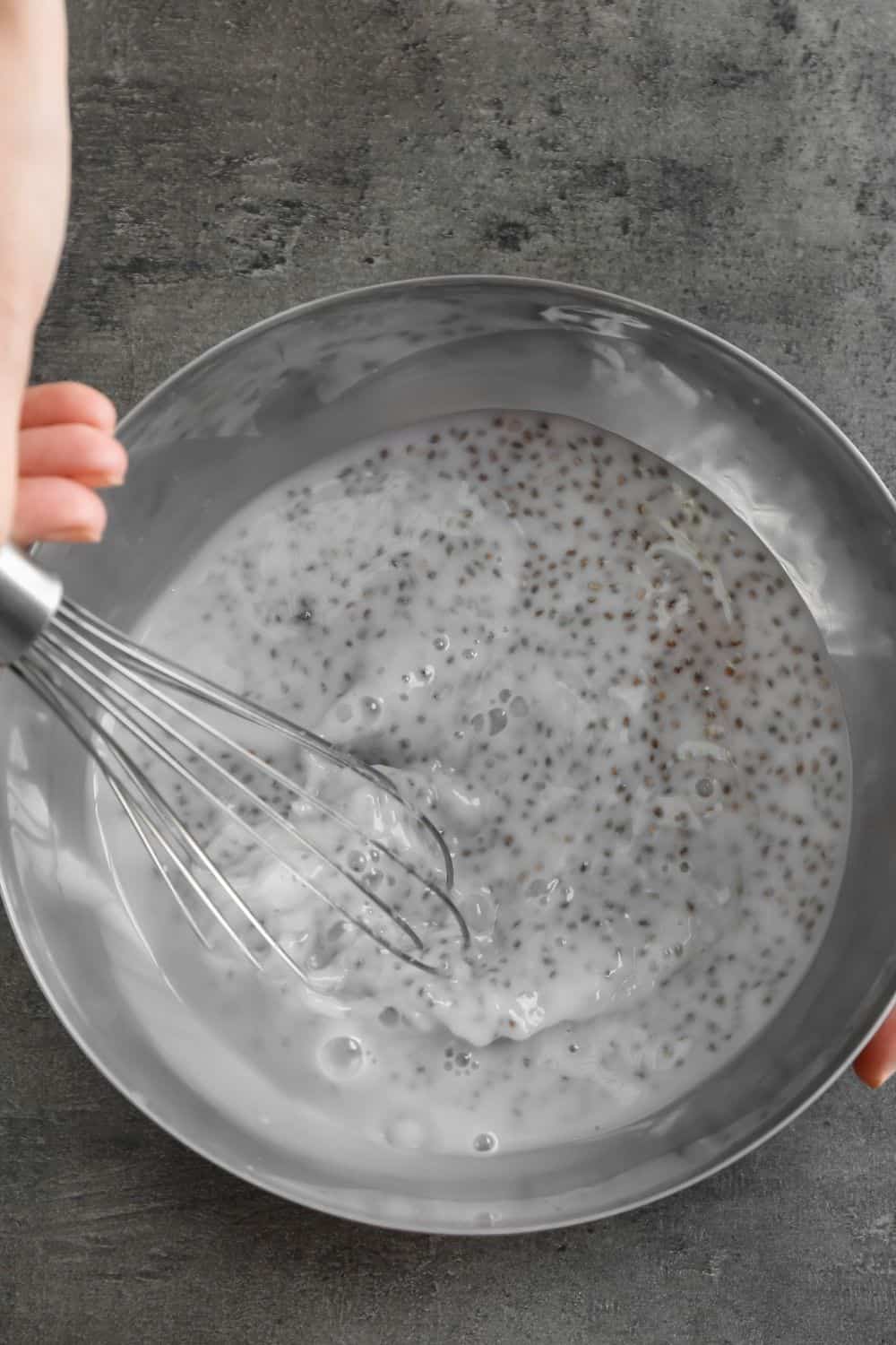 Image of chia seed pudding being made with yogurt and chia seeds.