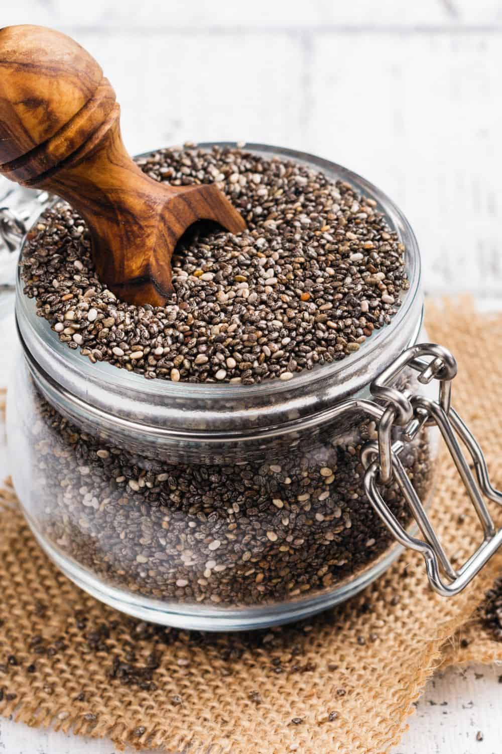 Mason jar full of chia seeds. The image is for a recipe post on chia seeds for breakfats.