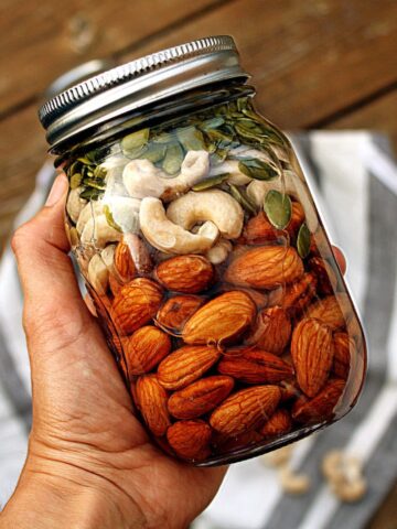 Image of a jar of various nuts and seeds being soaked in water