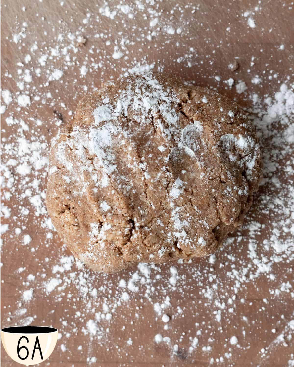 The vegan Zimtsterne dough on a surface, dusted with powdered sugar, ready to be rolled and cut into cookie shapes.