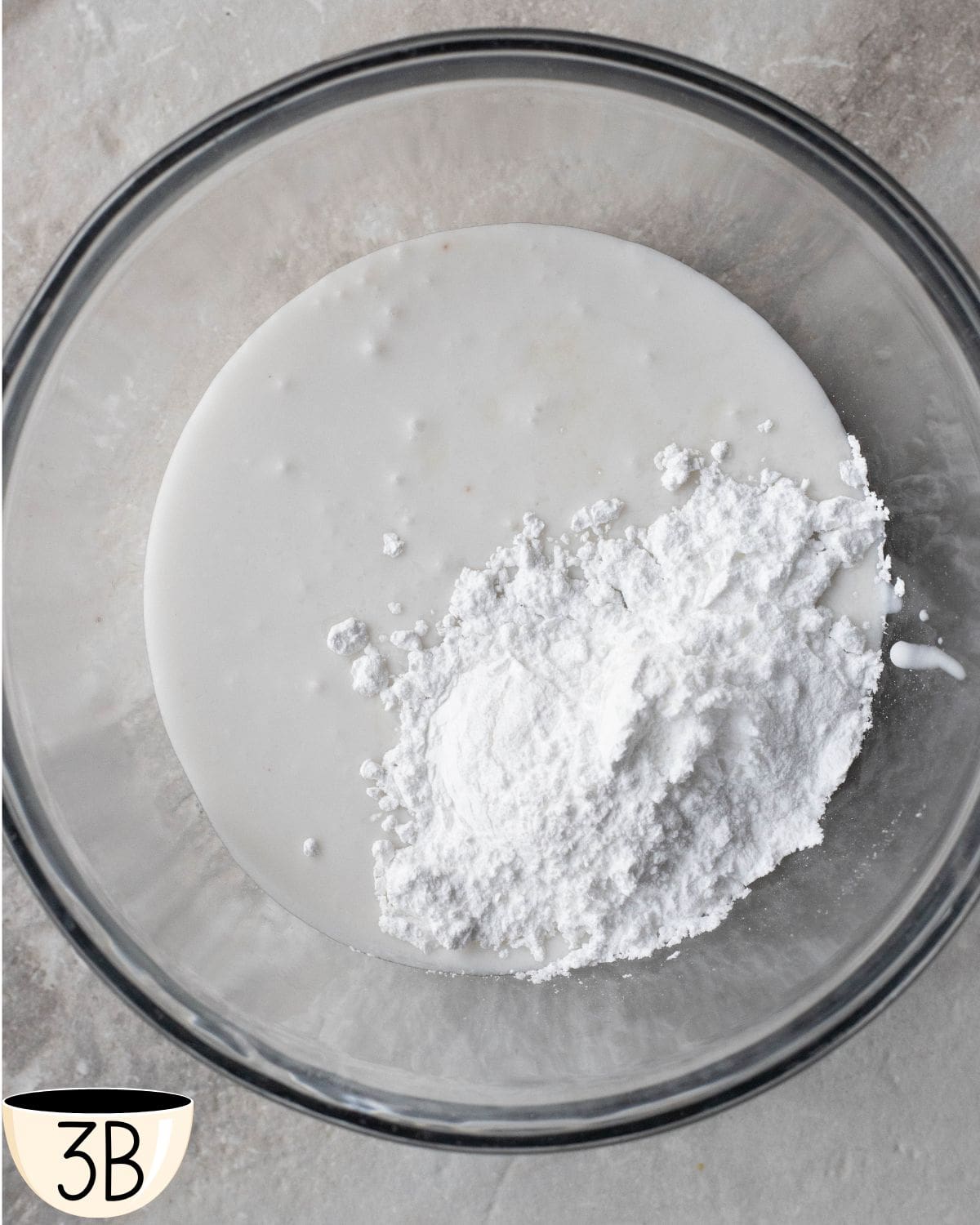 This photo shows the beginning of the whipping process for the coconut cream and powdered sugar, with the dry ingredients just starting to combine with the liquid.