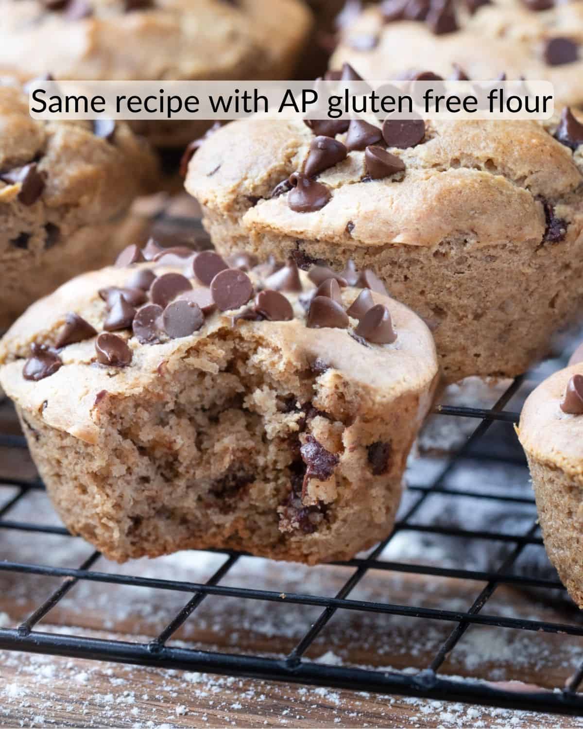 Gluten-free muffins baked with all-purpose gluten-free flour mix, displayed on a wire rack, topped with chocolate chips, and one muffin broken open to show the texture.