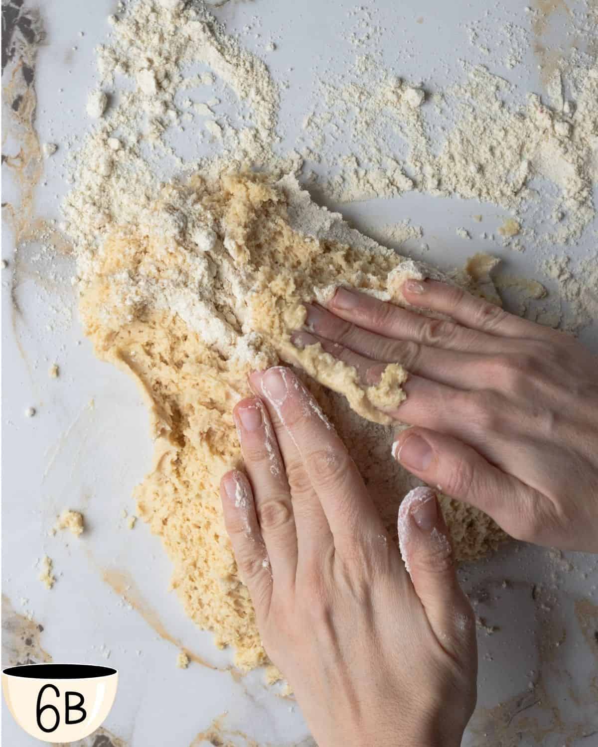 Hands kneading the dough on a floured surface, an important step in developing the texture for gluten-free bagels.