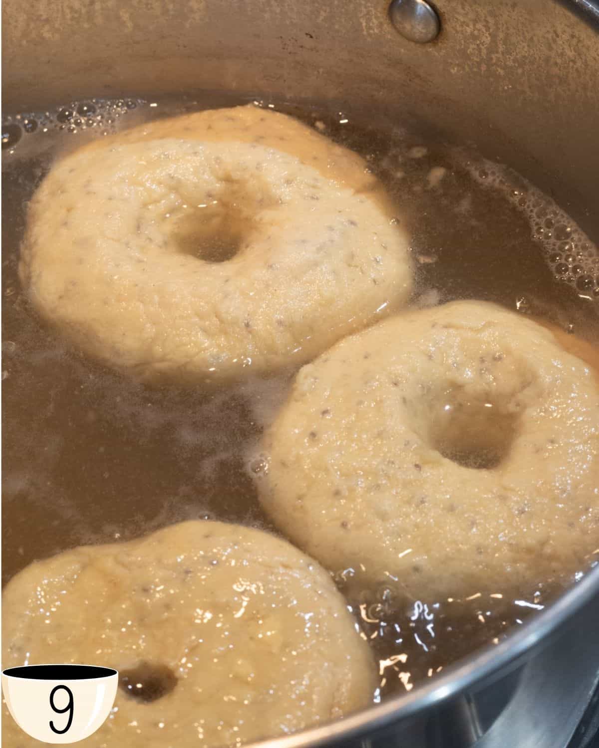 Gluten-free vegan bagels boiling in a pot of water.