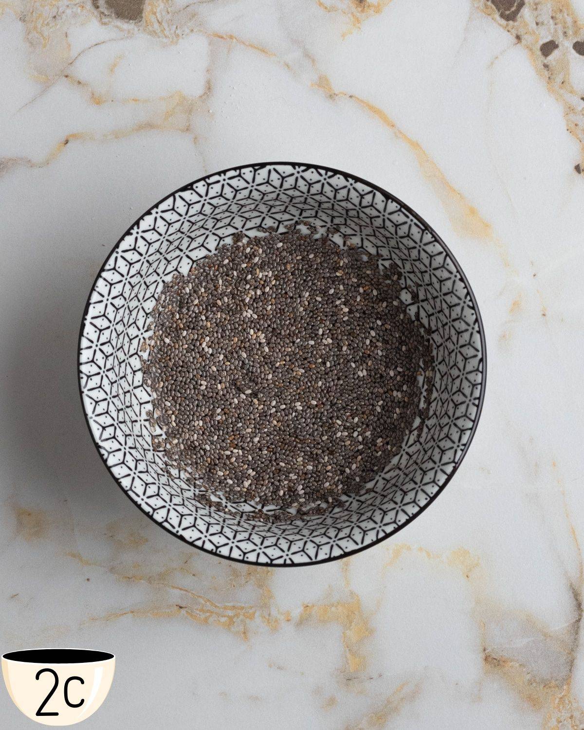 Chia seeds fully mixed with water in a bowl forming a gel-like consistency, known as a chia egg.