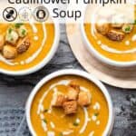 Heartwarming bowl of roasted pumpkin cauliflower soup, easy and healthy, topped with a swirl of dairy-free cream.