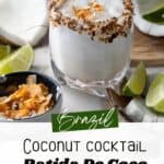 Two glasses of Brazilian Batida De Coco cocktail with toasted coconut rims, surrounded by coconut halves and lime wedges.