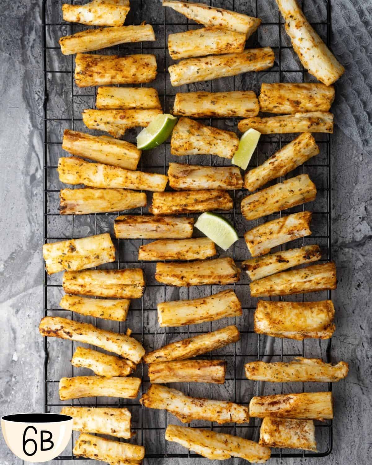 Golden brown yuca fries cooling on a wire rack with lime wedges placed among them, fresh out of the air fryer